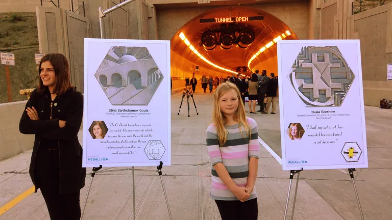 Ellina Bartholomew Couts (left) stands by her medallion design, which depicts all four bores of the Caldecott Tunnel. Also pictured is Nuala Gorshow.