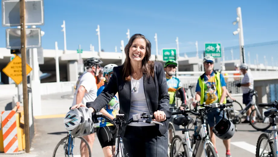 Oakland Mayor and MTC Commissioner Libby Schaaf poses with her bicycle