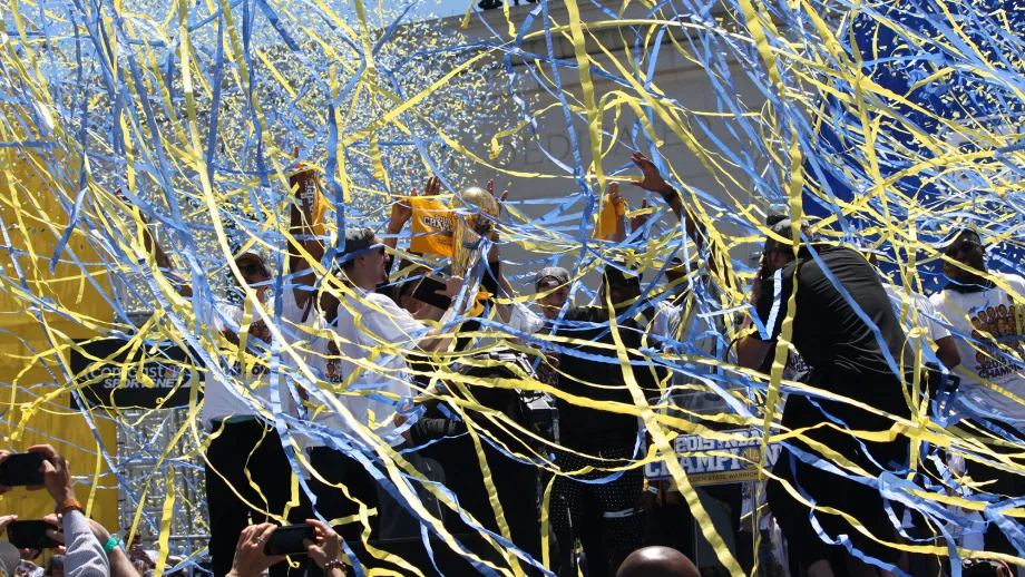 The confetti and streamers rain down on the players and officials on the stage.