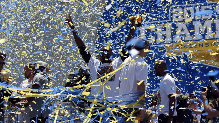 A player emerges from the confetti and streamers, making the V sign with his arms.