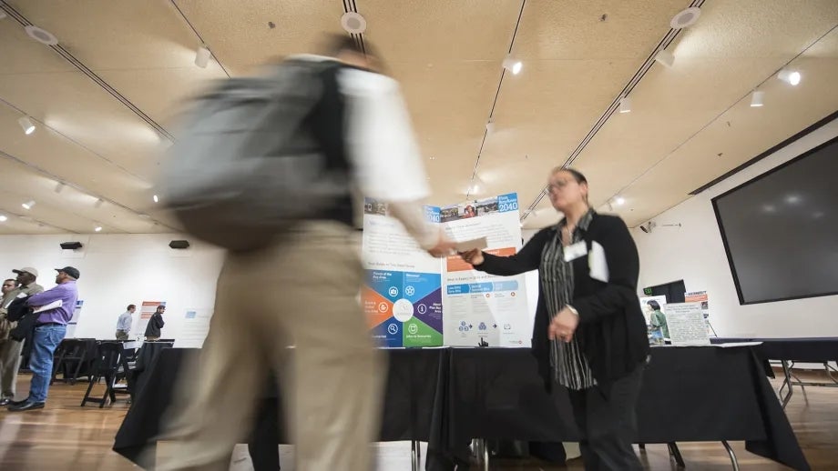 Two people shaking hands at an expo