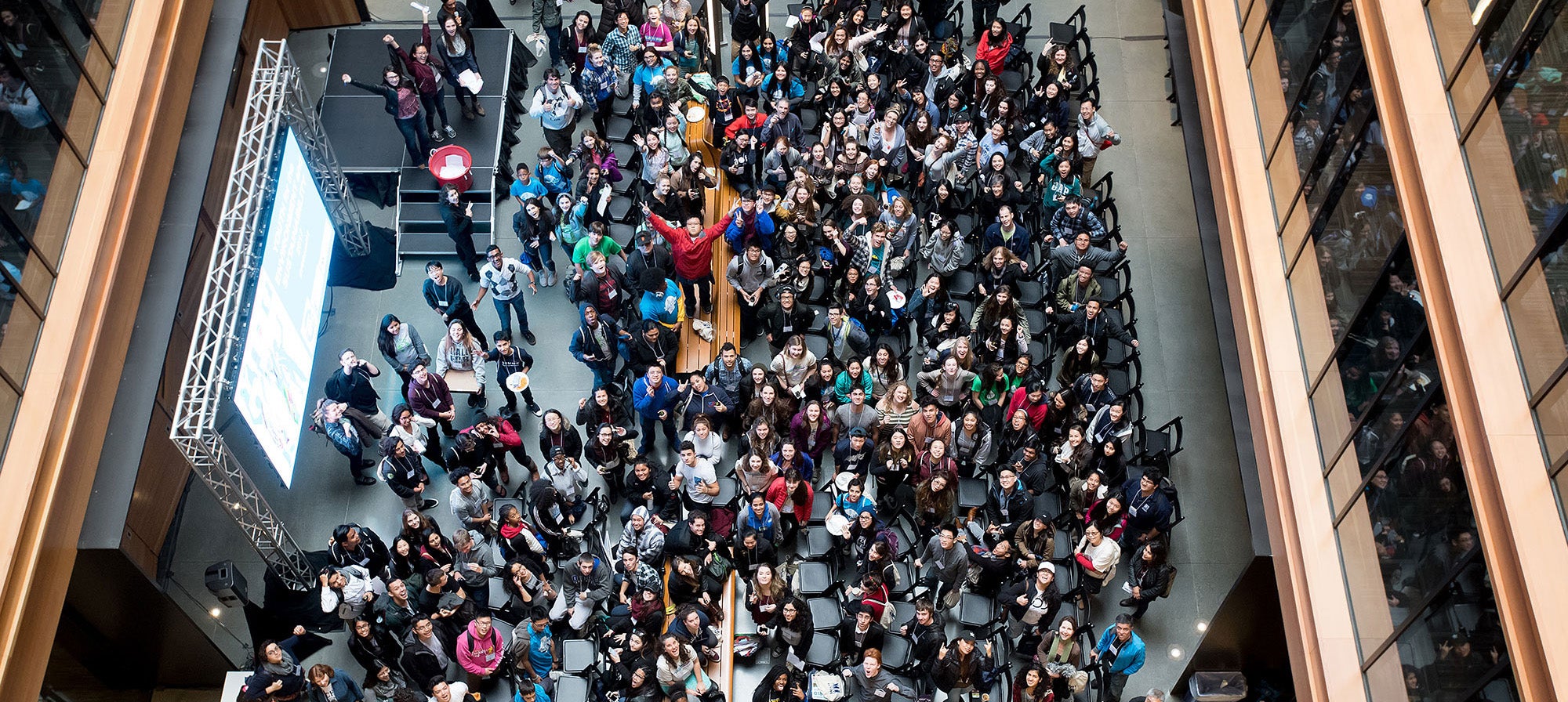 View looking down on people gathering in the Metro Center atrium lobby.