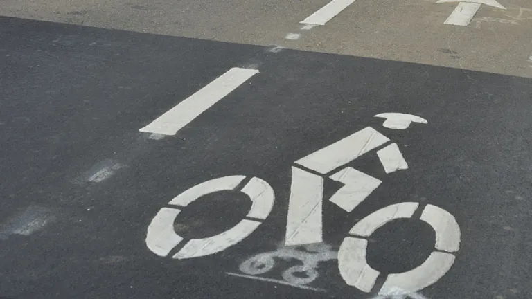 Bike lane symbol painted on a roadway.
