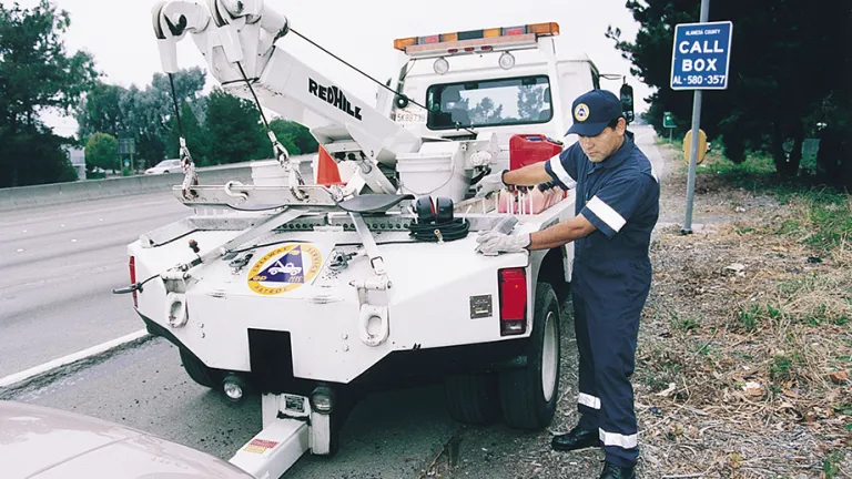A Freeway Service Patrol tow truck operator assists a motorist.