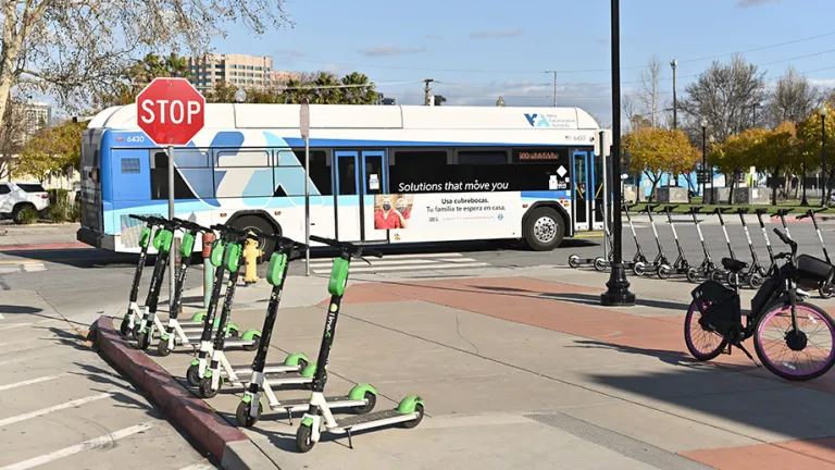 Scooter and bike share at a bus station.
