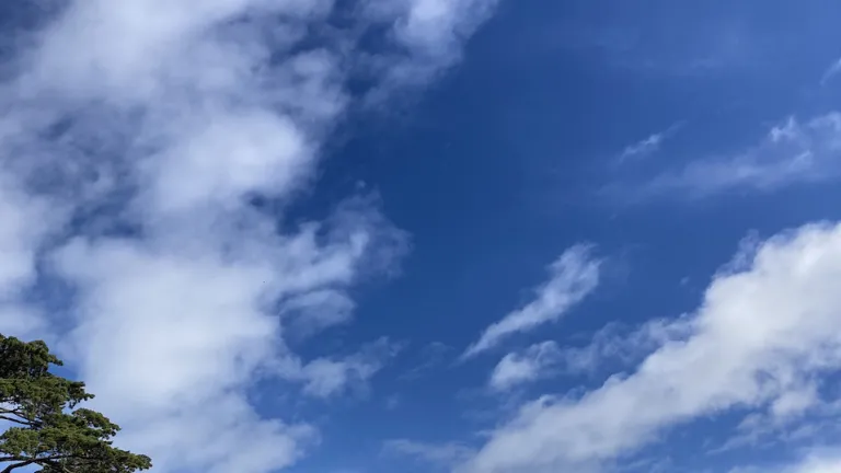 Photo of blue sky with a few clouds 