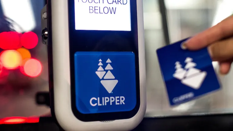 A person using a Clipper Card for fare payment
