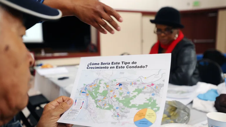  Members of the public read planning materials in Spanish