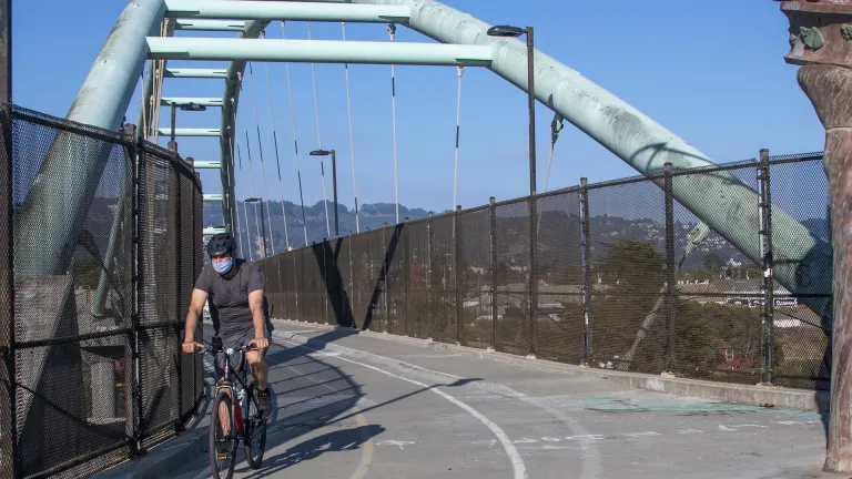 Cyclist riding on the bicycle/pedestrian bridge near the Berkeley Marina.