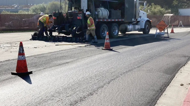 Road maintenance crews laying fresh tar on a road in San Francisco's Crissy Field.