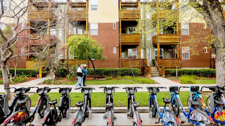 A residential housing complex with a bike share dock in the foreground.