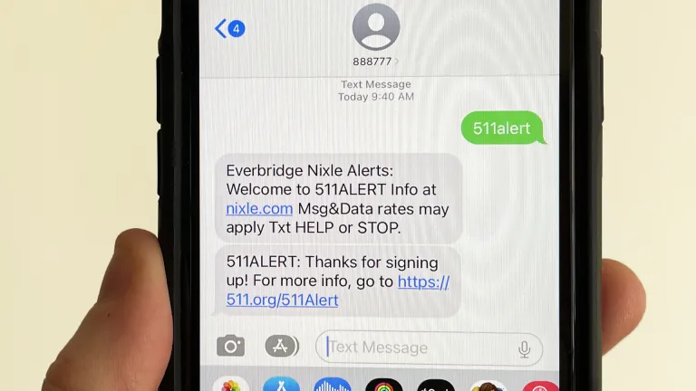 A cell phone with a text thread signing up for 511 alert.