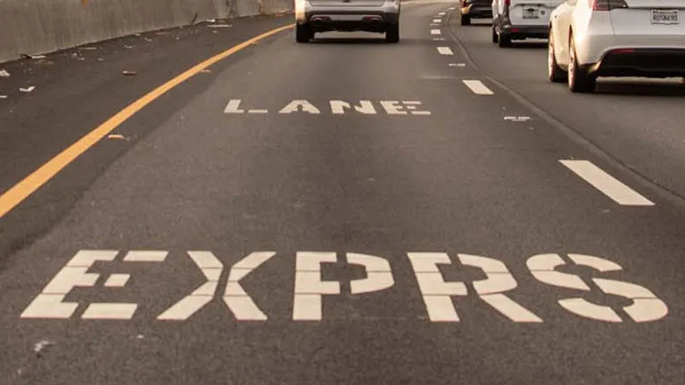 Closeup of Express Lane text on a roadway.