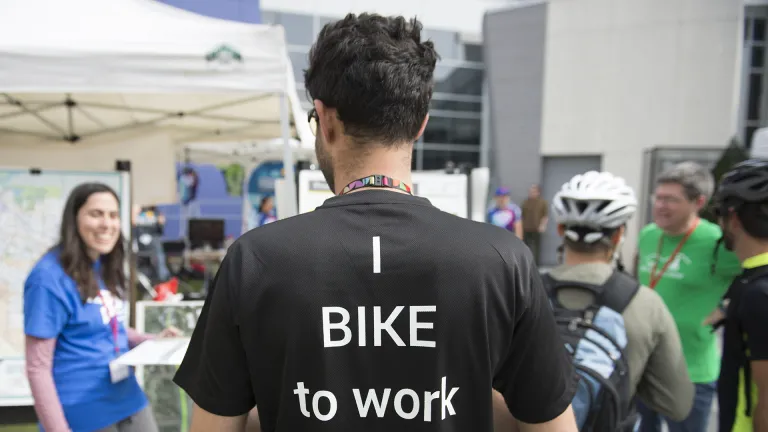 The back of a cyclist's shirt that reads, "I bike to work."