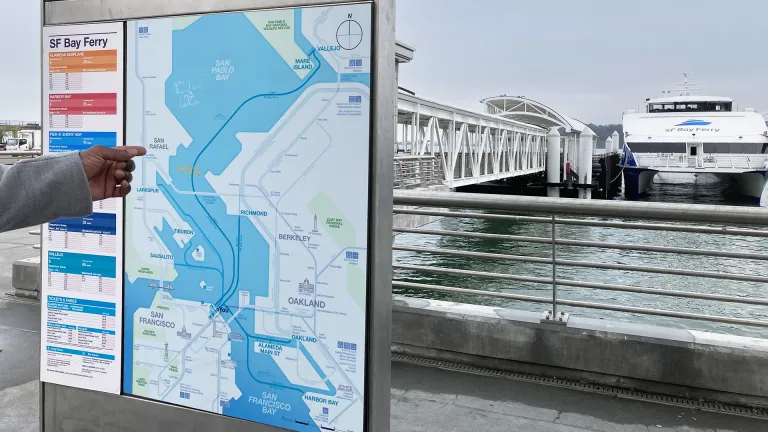A person points to a ferry system map at the San Francisco Ferry Building.