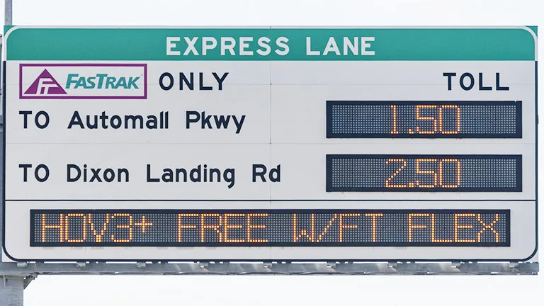 Overhead gantry sign above a freeway, indicating Express Lane usage rules and the fee to use the Express Lane if you are not in a carpool.