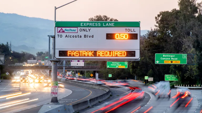 An Express Lanes overhead sign that reads FasTrak Required.