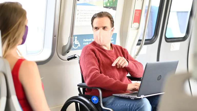A BART passenger in a wheelchair talking to another BART rider.