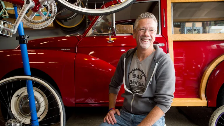 Bill Bradford in his garage with bicycles and a vintage truck