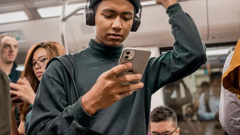 Man on subway looking at phone