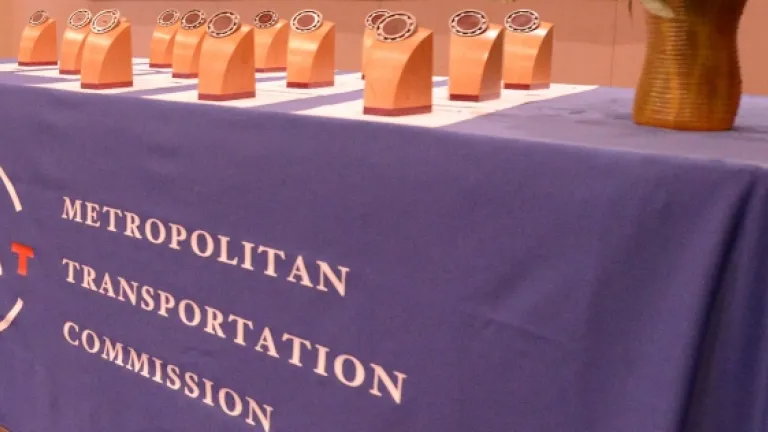A table draped in MTC tablecloth and awards placed on top.