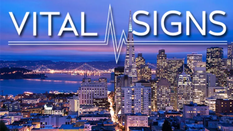 A photo of the SF Bay at night, with San Francisco city lights on and Vital Signs logo imposed on top