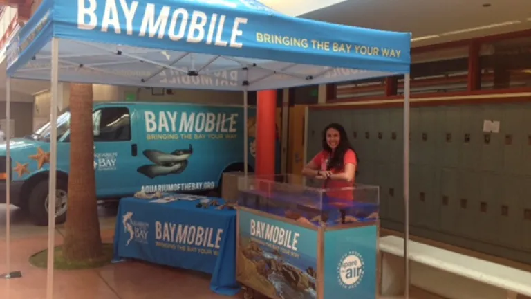 Blair Bazdarich, K-12 outreach coordinator, with the BayMobile touch-tank and van. 
