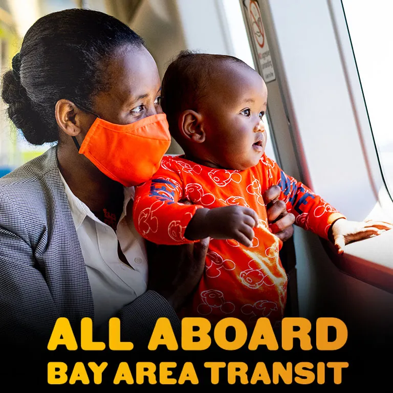 All Aboard Bay Area Transit - a masked Black woman and her child on a BART train.