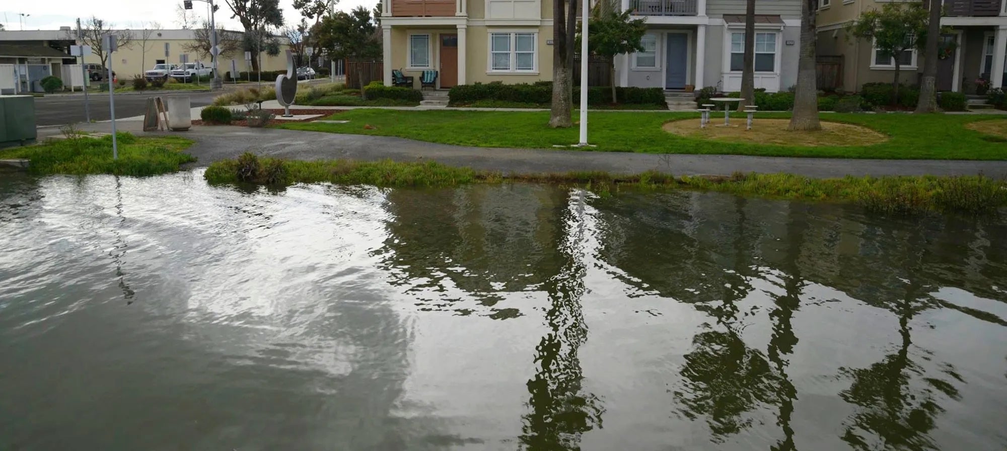 The Grand Marina's footpath in Alameda. The new condos have raised steps up to their front doors (about 1 foot high), but during a high tide with storm surges residents will have to walk through water to get to their front doors.