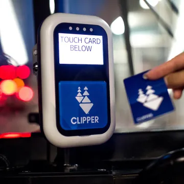 A person using a Clipper Card for fare payment