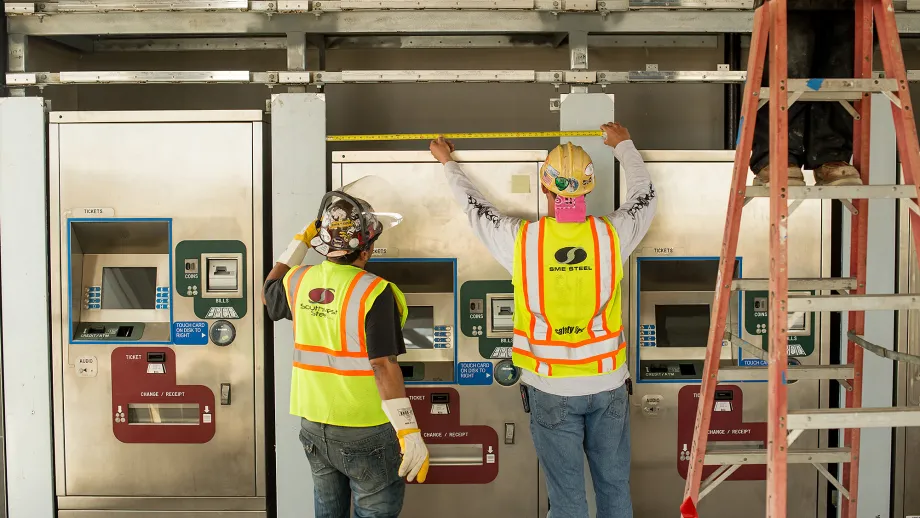Warm Springs BART Station: Workers install ticket machines.