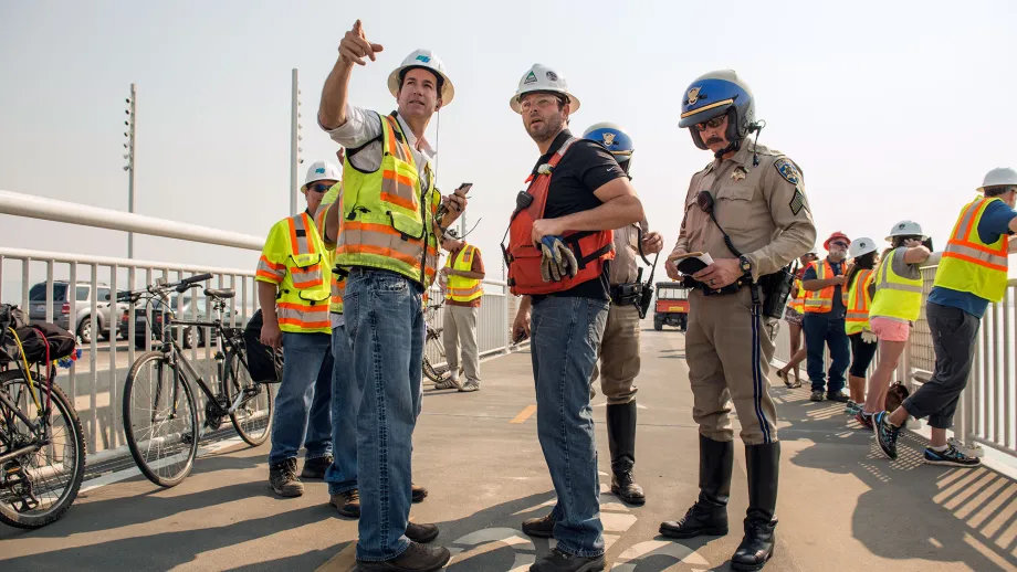 construction workers and police officer on bay bridge