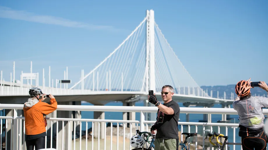 Cyclist takes selfie with East Span tower in the background