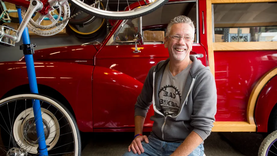 Bill Bradford in his garage with bicycles and a vintage truck