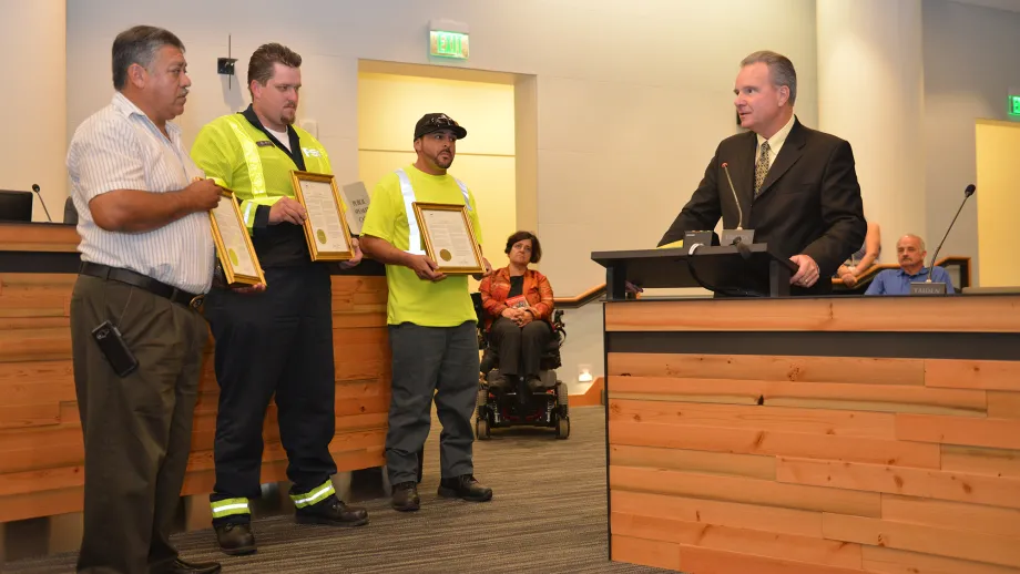 Freeway Service Patrol tow truck drivers Moises Reyes and Darryl Poe, and Waste Management of Alameda County driver David Garcia receive their awards from MTC Chair Dave Cortese