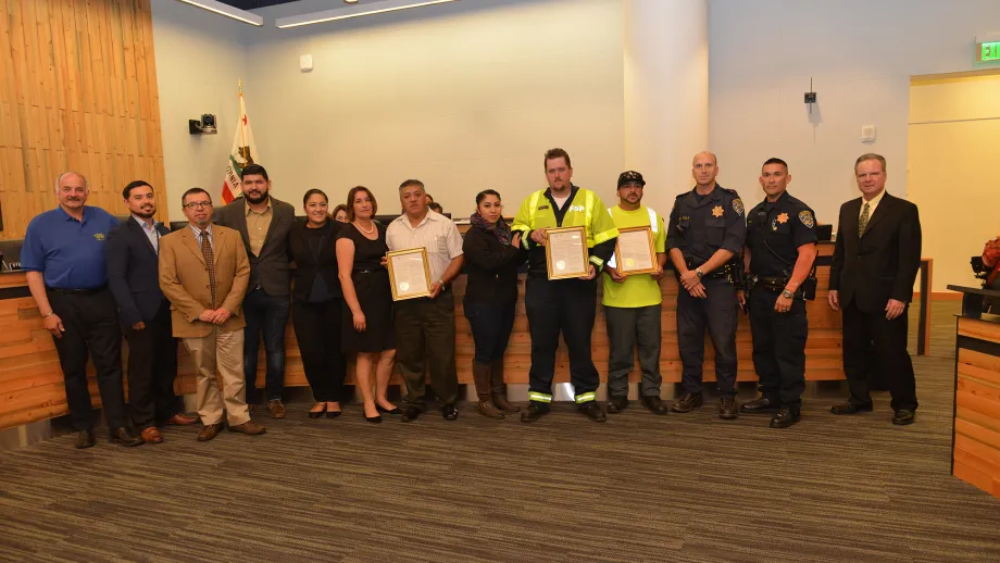 Freeway Service Patrol tow truck drivers Darryl Poe and Moises Reyes, Waste Management of Alameda County driver David Garcia and MTC Chair Dave Cortese with family and friends