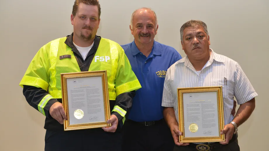 Freeway Service Patrol tow truck drivers Darryl Poe and Moises Reyes holding their awards