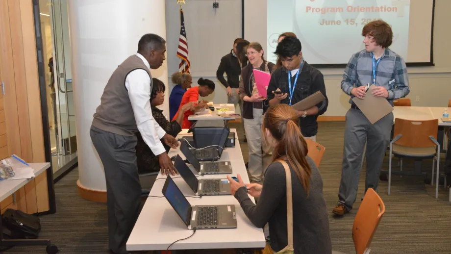 group of people sitting at table using tablets
