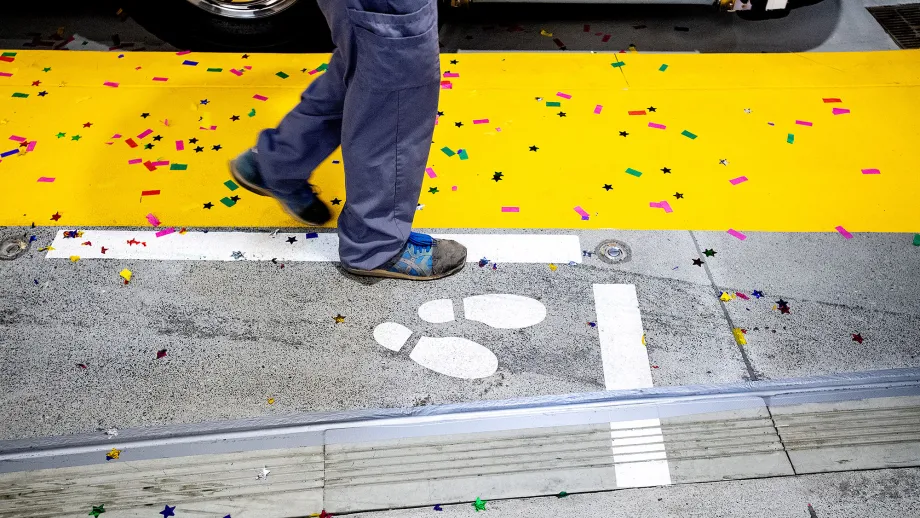 Confetti covers a platform as the first regular service AC Transit bus arrives at the Salesforce Transit Center