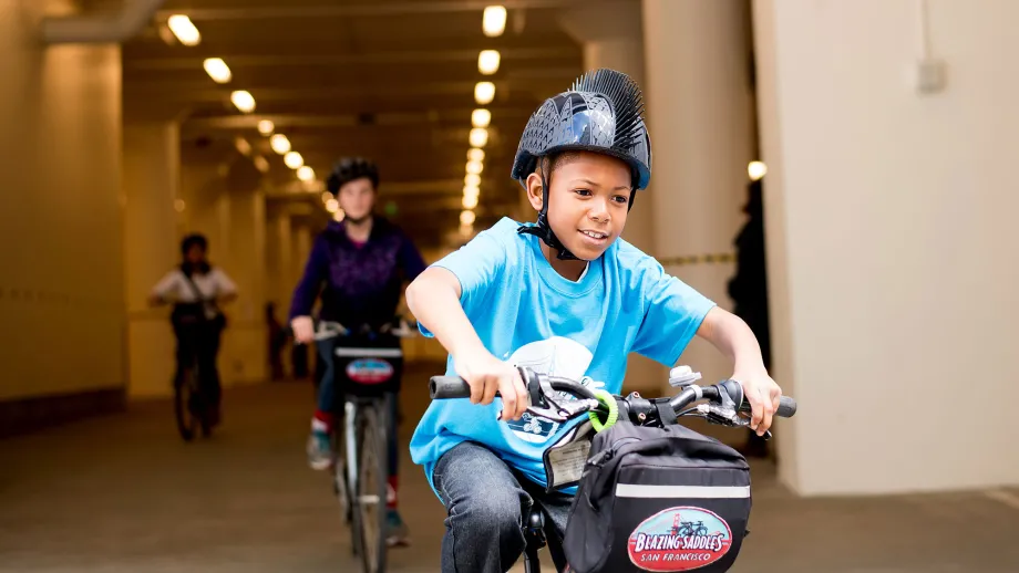 child riding a bike with a helmet on