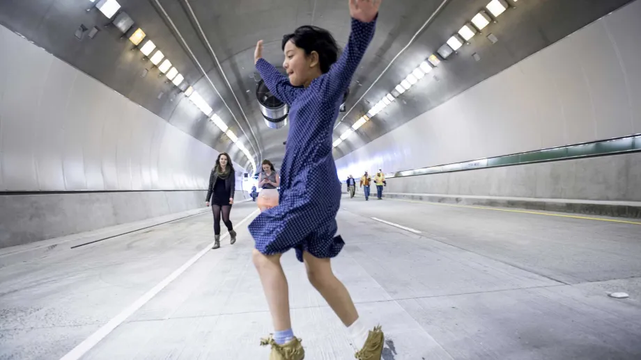 For young medallion artist Chaya Tong, the still-empty tunnel inspires a joyful leap.