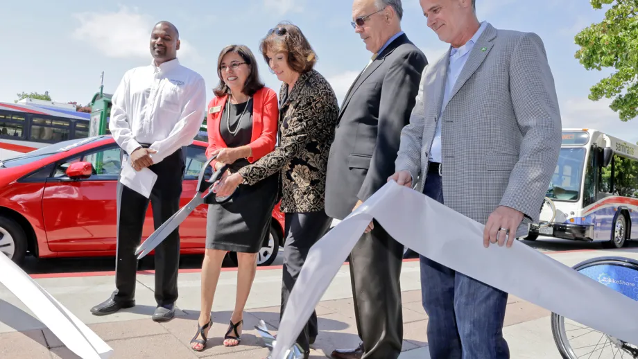 Officials cut a ceremonial ribbon encircling the wide range of transportation choices. From left: Dalton Victor, Silver Spring engineer; Alicia Aguirre, MTC Commissioner and Redwood City Mayor; Adrienne Tissier, MTC Commissioner and San Mateo County Super