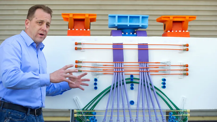 Bill Casey, resident engineer for the Bay Bridge's SAS project, uses a model to explain how post-tensioned tendons will reinforce the East Span.