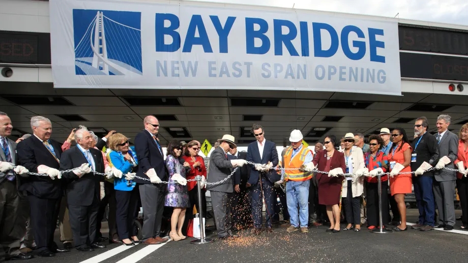 Gavin Newsom, then-Lieutenant Governor, uses a blowtorch to cut the chain for the opening of the East Span of the San Francisco-Oakland Bay Bridge.