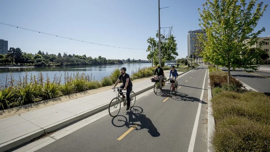 Cyclists ride on a separated bike path in Alameda County.