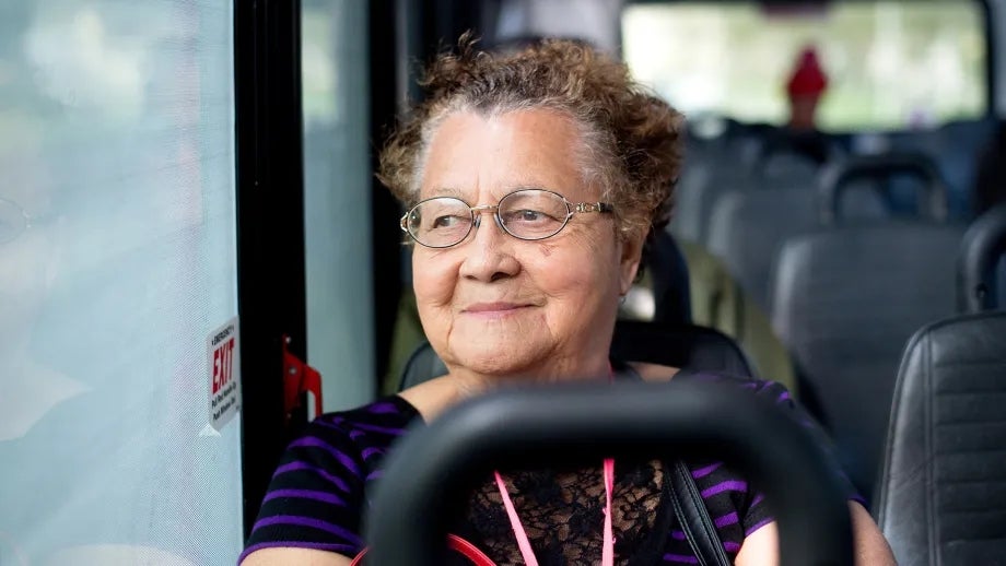 A senior rides on a South City shuttle bus.
