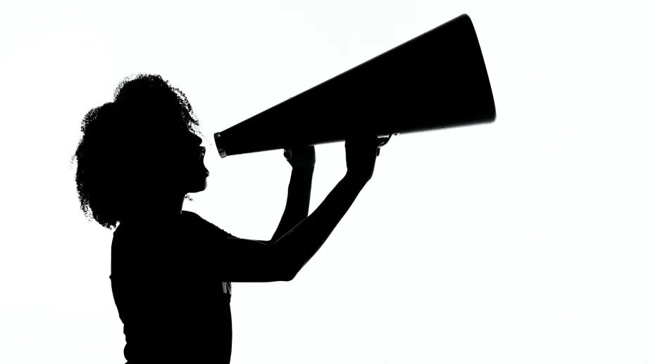 Silhouette of a woman using a megaphone.