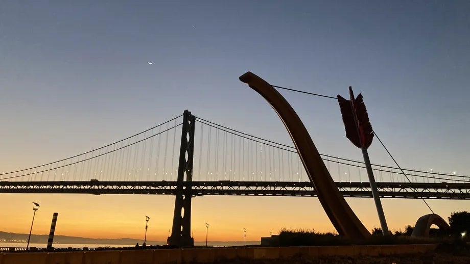 The Cupid’s Span sculpture and San Francisco-Oakland Bay Bridge at dawn.