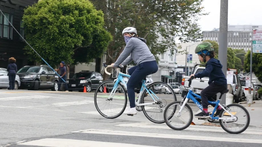 An adult and child riding bicycles in San Francisco.