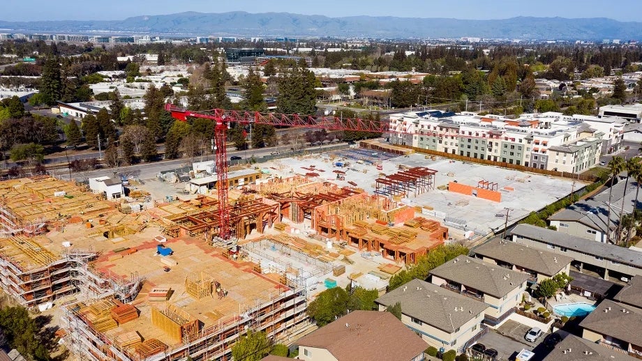 A large apartment building under construction in a residential neighborhood in the South Bay.